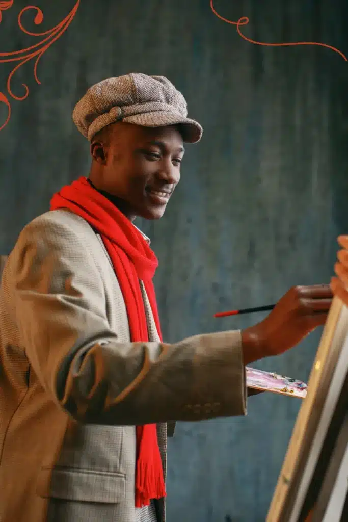 Black male painter, happy and painting.