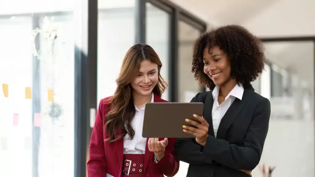 Minority Business Owner reviewing business numbers with another person