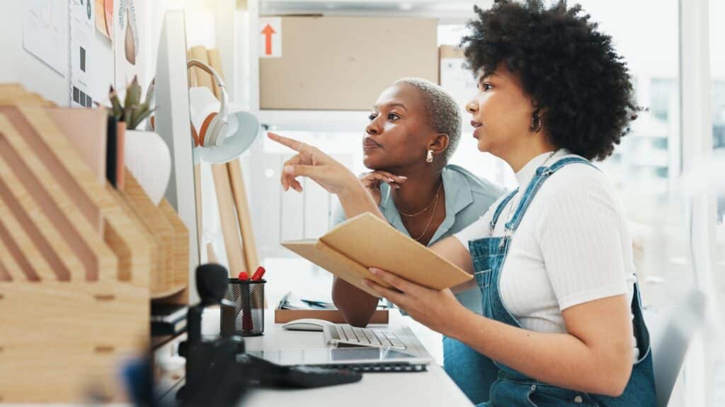 Black, women and business startup of employee working with coach on marketing plan or strategy on c