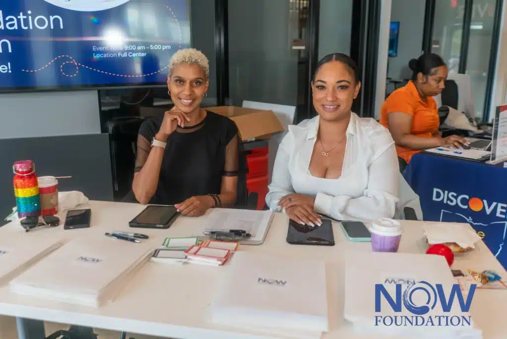 People sitting at a table during an event or meeting
